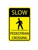 Yellow and black sign indicating 'Slow Pedestrian Crossing' with a pedestrian icon