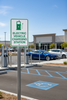 Electric vehicle charging station sign at a commercial parking lot