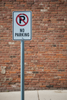 No parking sign 12"x18" installed on a sign post