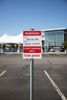 Reserved event parking sign in a parking lot with a building in the background