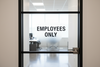Employee only decal in matte black installed on a business door 