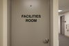 Door with 'Facilities Room' text in an indoor setting