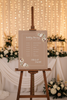 Wedding timeline sign displayed on a easle at a wedding