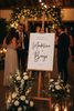 wedding welcome sign black and white on a easel at a wedding