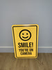 Smile! You're On Camera Sign Aluminum Composite 12”x18”x 3mm - BC Retail Supplies